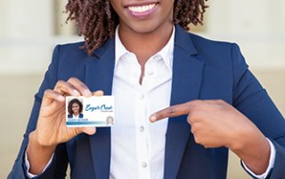 Woman holding photo ID badge